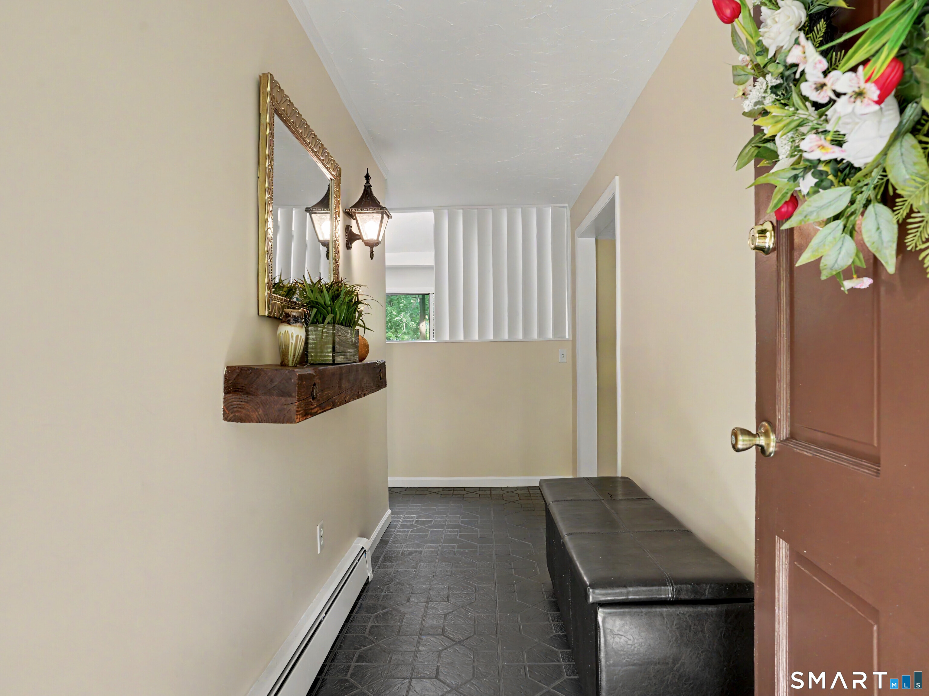 15 Flat Rock Drive Ridgefield, CT 06877 - Photo 4 of 39 a hallway with a flower pot and a bookshelf