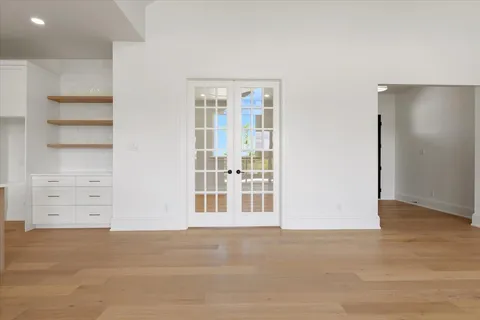 an empty room with ceiling fan and window