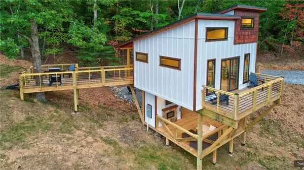 a view of a deck with table and chairs with wooden floor and fence