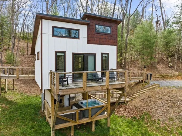 a view of a house with backyard and sitting area