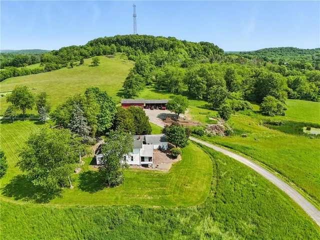 a backyard of a house with a yard and outdoor seating