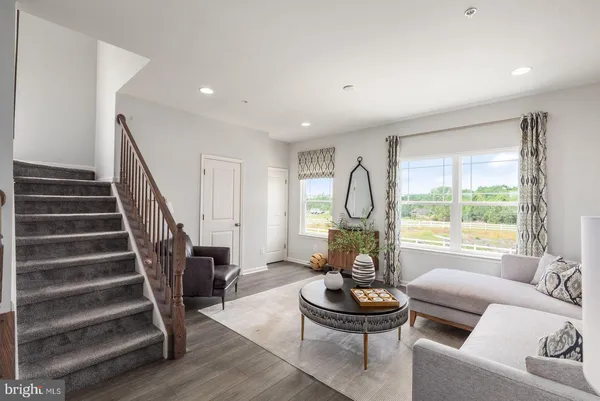 a living room with furniture a window and a fireplace