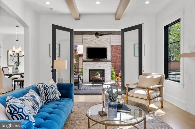 a living room with furniture fireplace and window