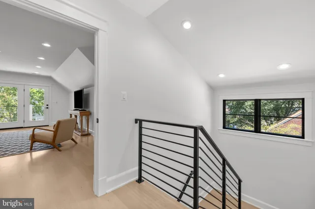 a view of hallway with furniture and a large window