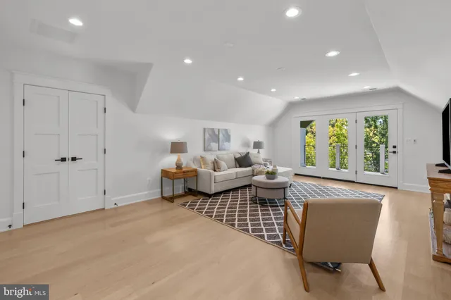 a bedroom with furniture and a large window