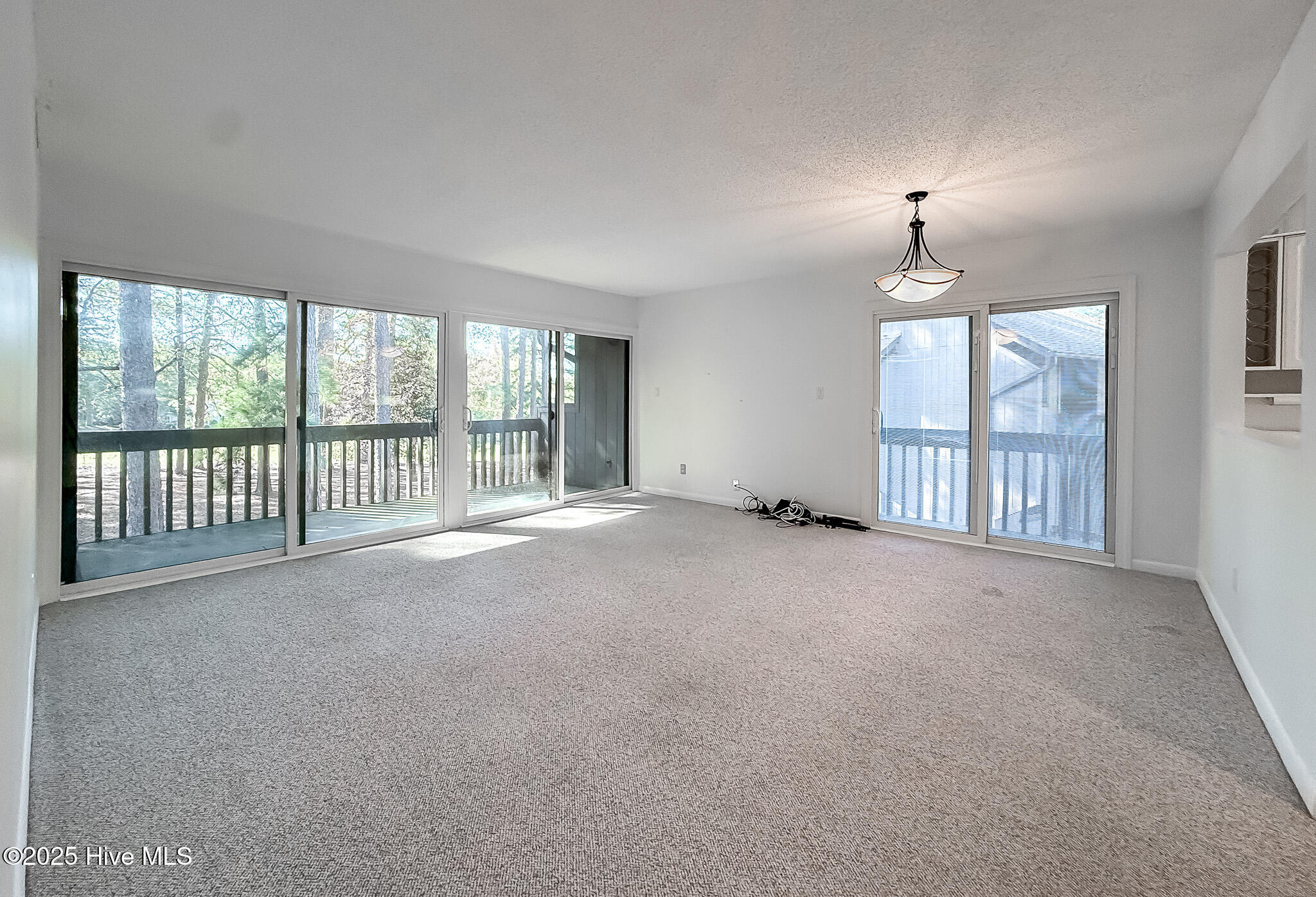 10 Pine Tree Road, Unit 203 Pinehurst, NC 28374 - Photo 11 of 42 Living Room/Dining area with 2 private decks