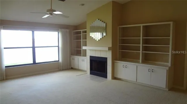 an empty room with windows and cabinet