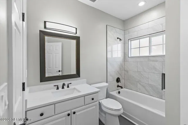 a view of a kitchen with a sink and a refrigerator