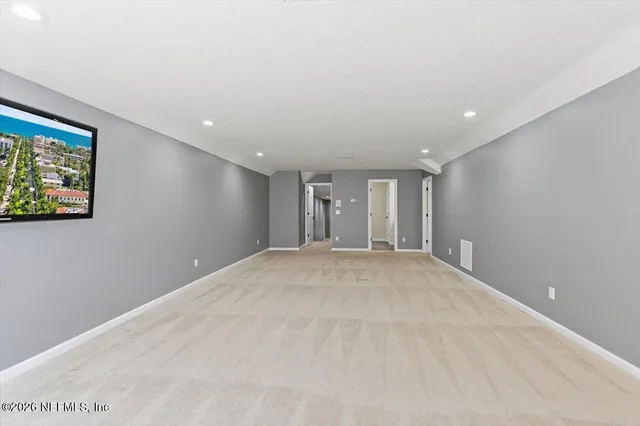 a house view with swimming pool and trees in the background