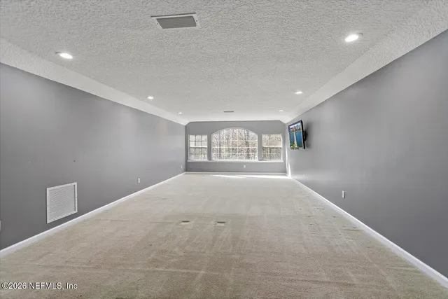 a view of a swimming pool and lounge chairs