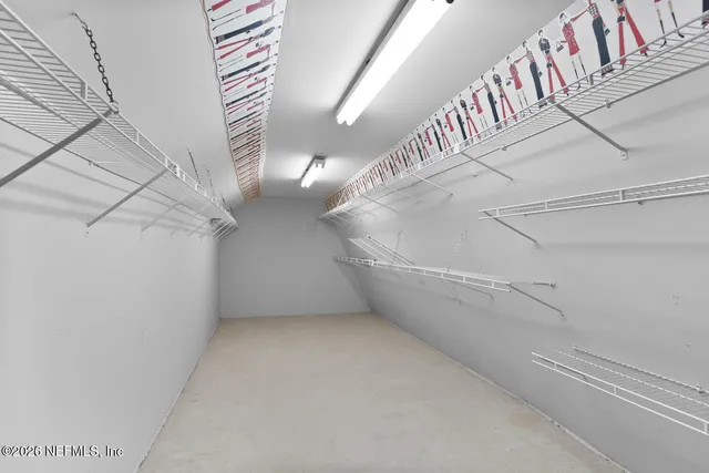 a view of a lake with a bench and trees