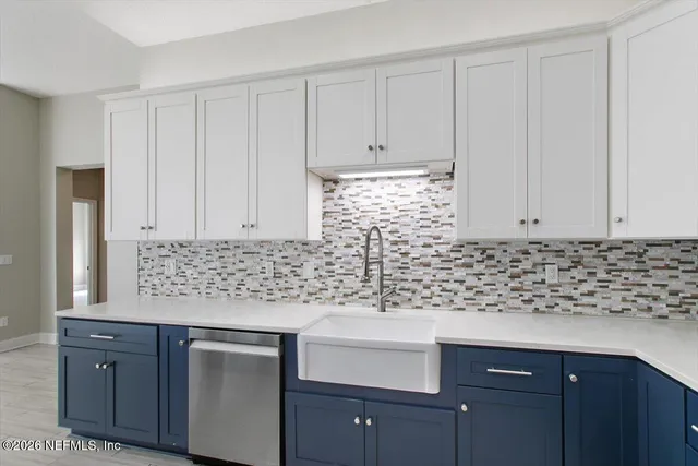 a large kitchen with stainless steel appliances and a refrigerator