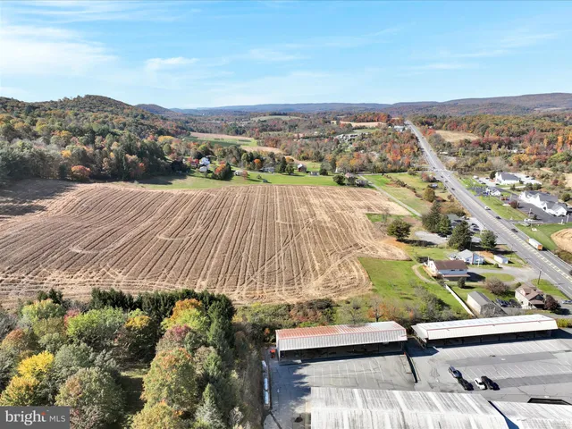 an aerial view of residential houses with outdoor space and seating