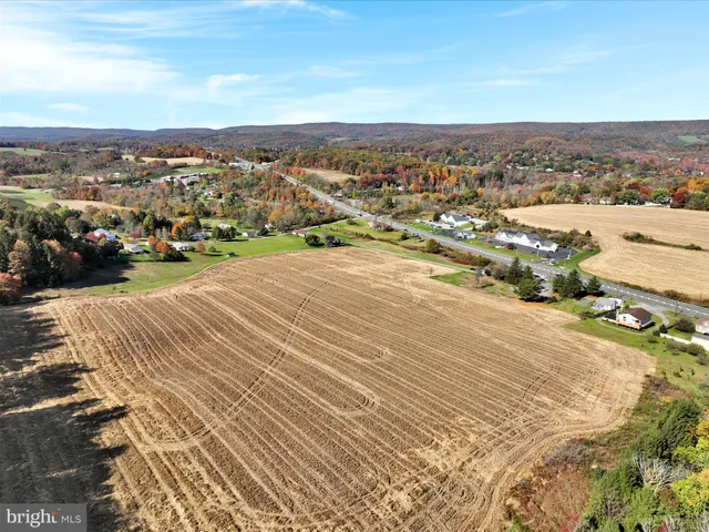 an aerial view of residential houses with city view