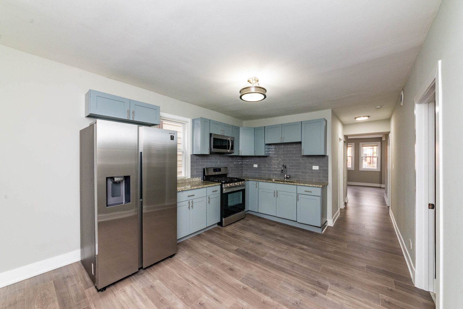 2923 North Avers Avenue, Unit 1 Chicago, IL 60618 - Photo 6 of 17 a large kitchen with a refrigerator and a sink