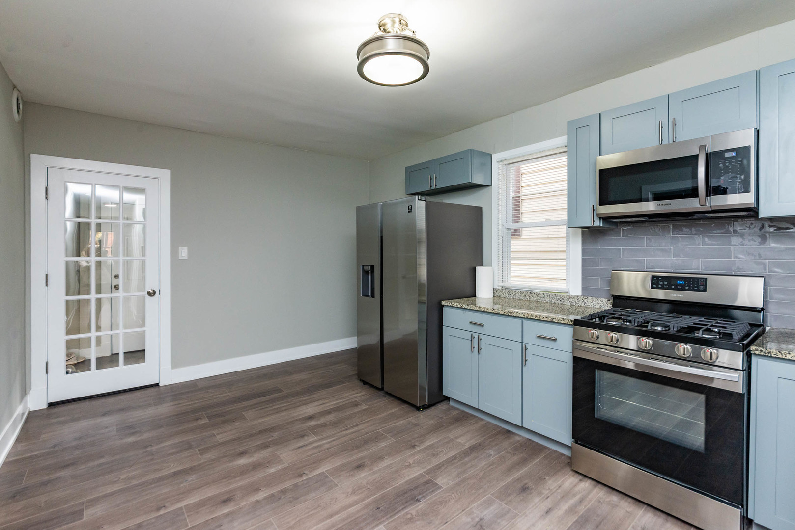 2923 North Avers Avenue, Unit 1 Chicago, IL 60618 - Photo 8 of 17 a kitchen with stainless steel appliances a stove a microwave and sink
