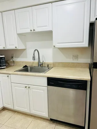 a white refrigerator freezer sitting in a kitchen