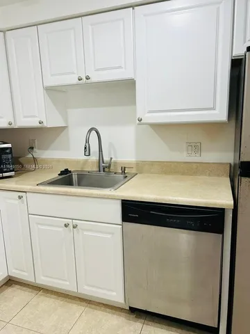 a white refrigerator freezer sitting in a kitchen