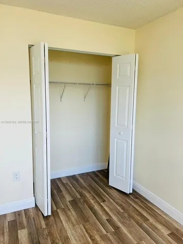 a bath tub sitting next to a white toilet and sink