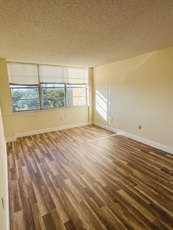 a view of a room with a wooden floor