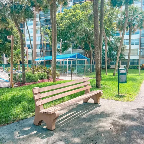 a view of green field with palm trees