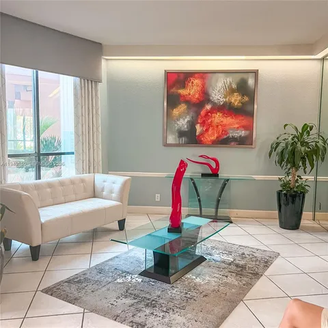 a room with pool table and chairs