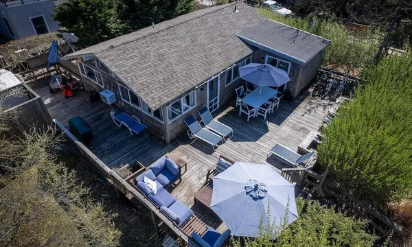 an aerial view of a house with a yard and balcony