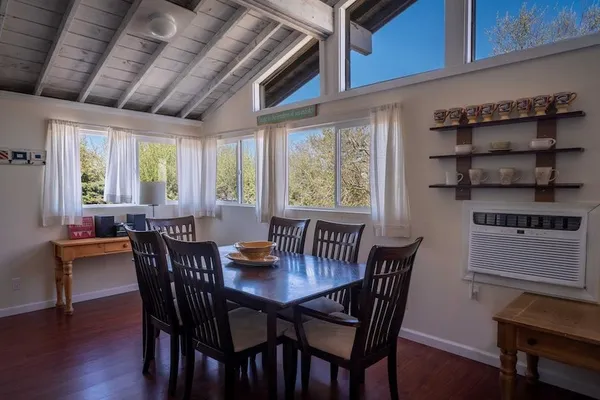 a view of a dining room with furniture and window