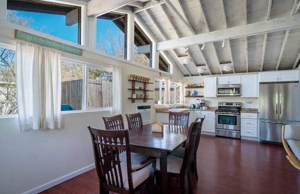 a view of a dining room with furniture window and wooden floor