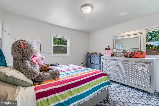 a bedroom with a bed and a dresser in it