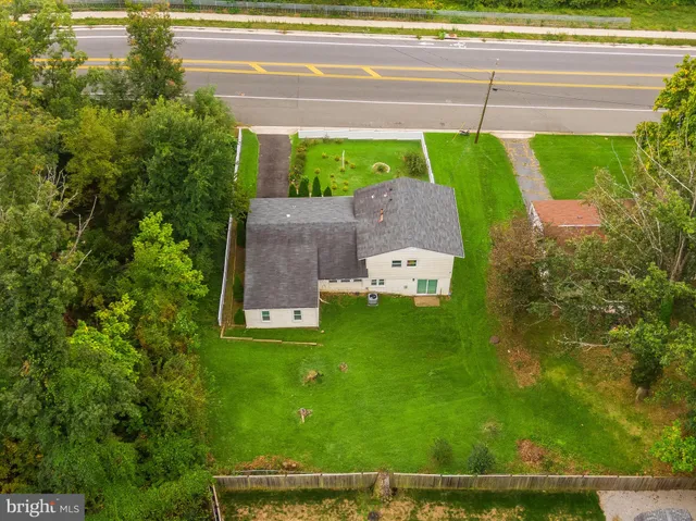 a aerial view of a house with a garden and yard