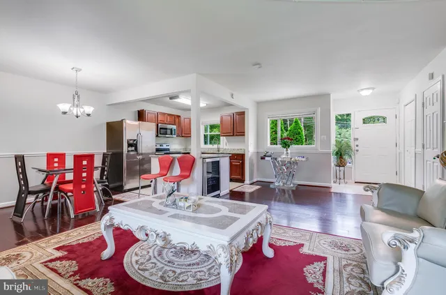 a living room with furniture and kitchen view