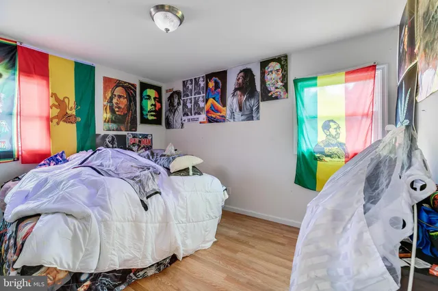 a bed sitting in a bedroom next to a window