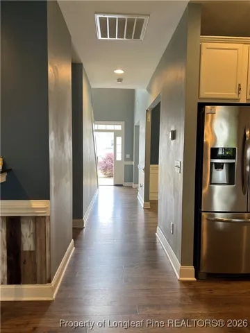 a view of a refrigerator in kitchen and wooden floor
