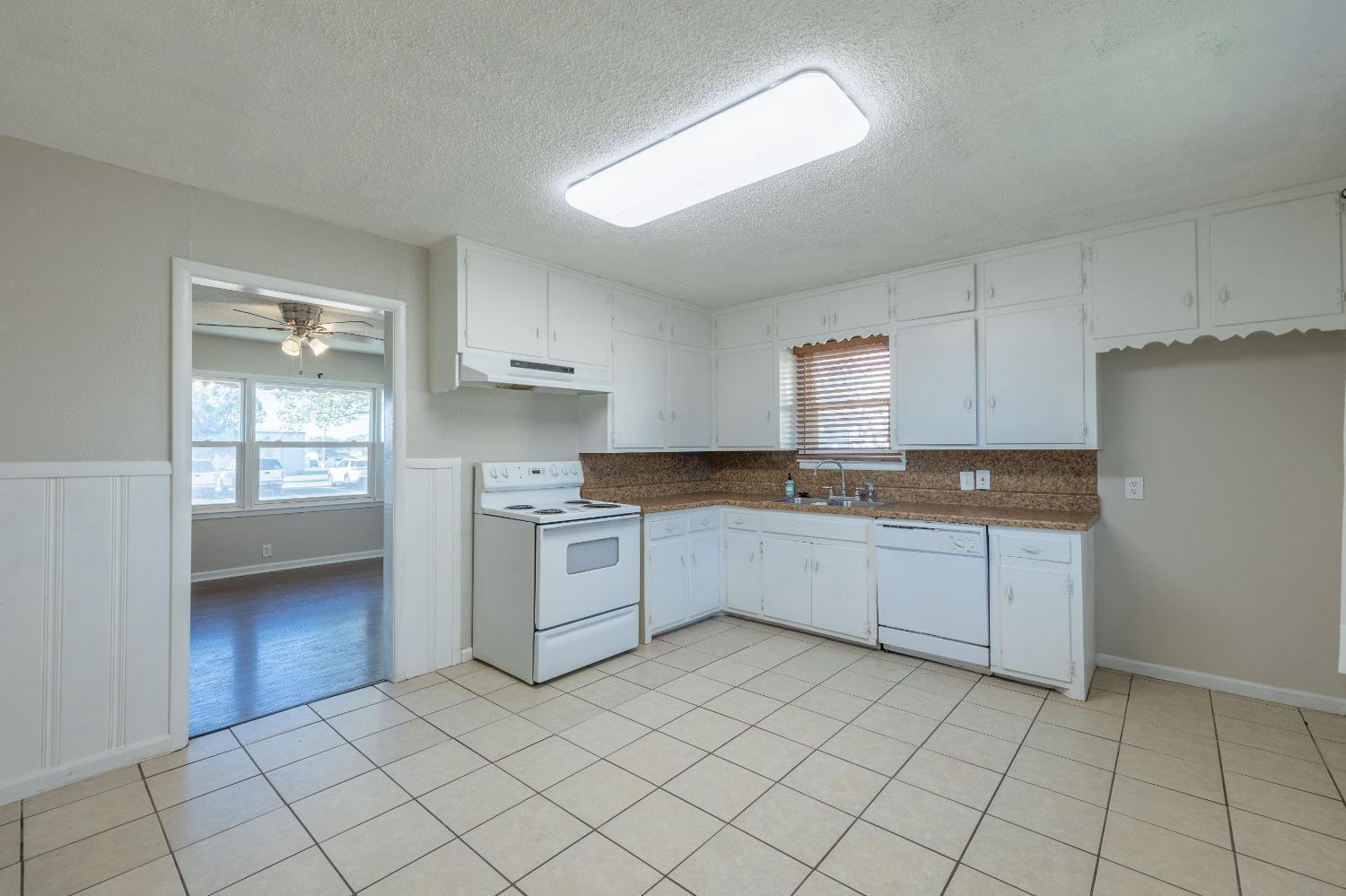 516 7th Street Wolfforth, TX 79382 - Photo 4 of 9 a kitchen with a sink cabinets and window