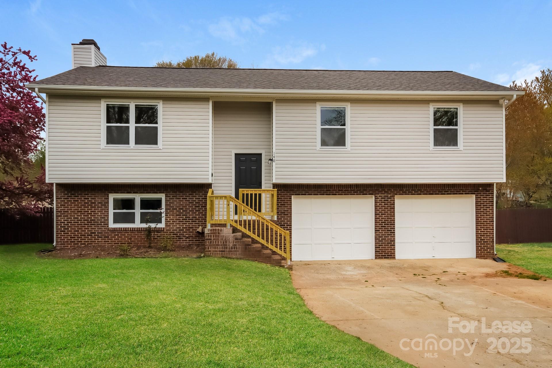 148 Mooreland Road Mooresville, NC 28117 - Photo 1 of 17 a front view of a house with a yard and garage