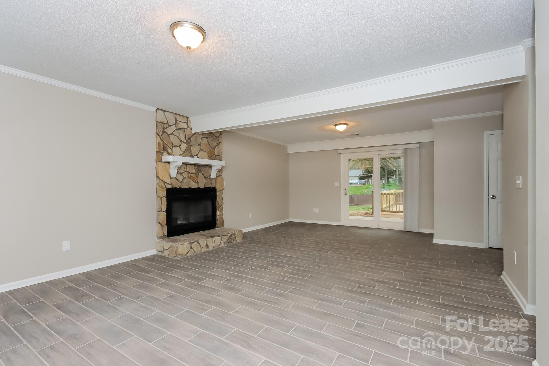 148 Mooreland Road Mooresville, NC 28117 - Photo 3 of 17 a view of an empty room with window and wooden floor