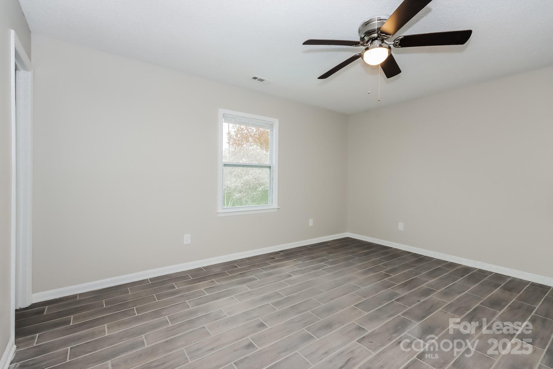 148 Mooreland Road Mooresville, NC 28117 - Photo 7 of 17 wooden floor in an empty room with a window