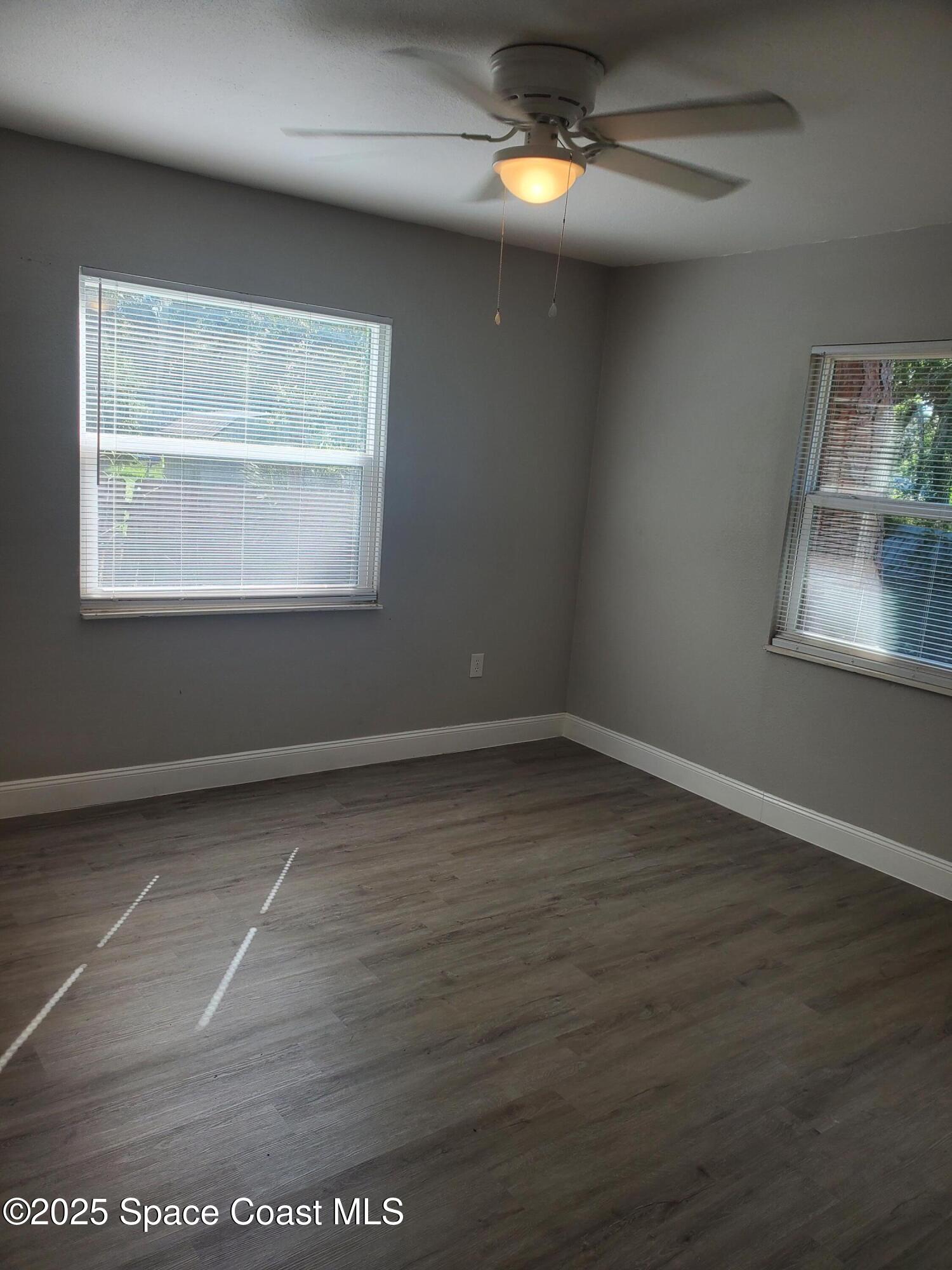 1105 Santa Rosa Drive Rockledge, FL 32955 - Photo 12 of 16 an empty room with wooden floor and windows