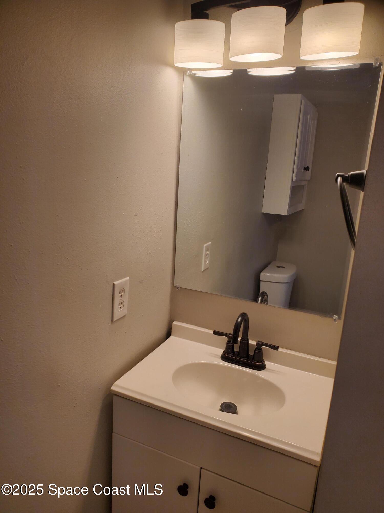 1105 Santa Rosa Drive Rockledge, FL 32955 - Photo 14 of 16 a bathroom with a sink and a mirror