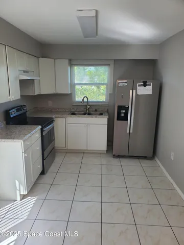 a kitchen with a sink a counter space and a window