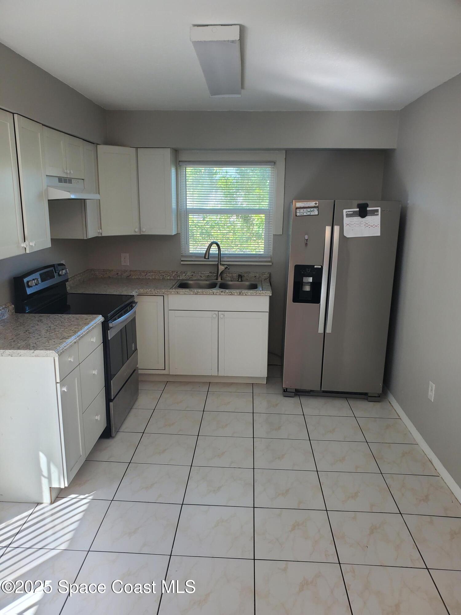 1105 Santa Rosa Drive Rockledge, FL 32955 - Photo 7 of 16 a kitchen with a sink a counter space and a window