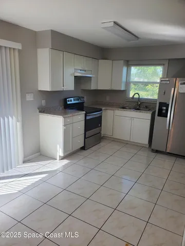 a kitchen with stainless steel appliances granite countertop a sink and cabinets
