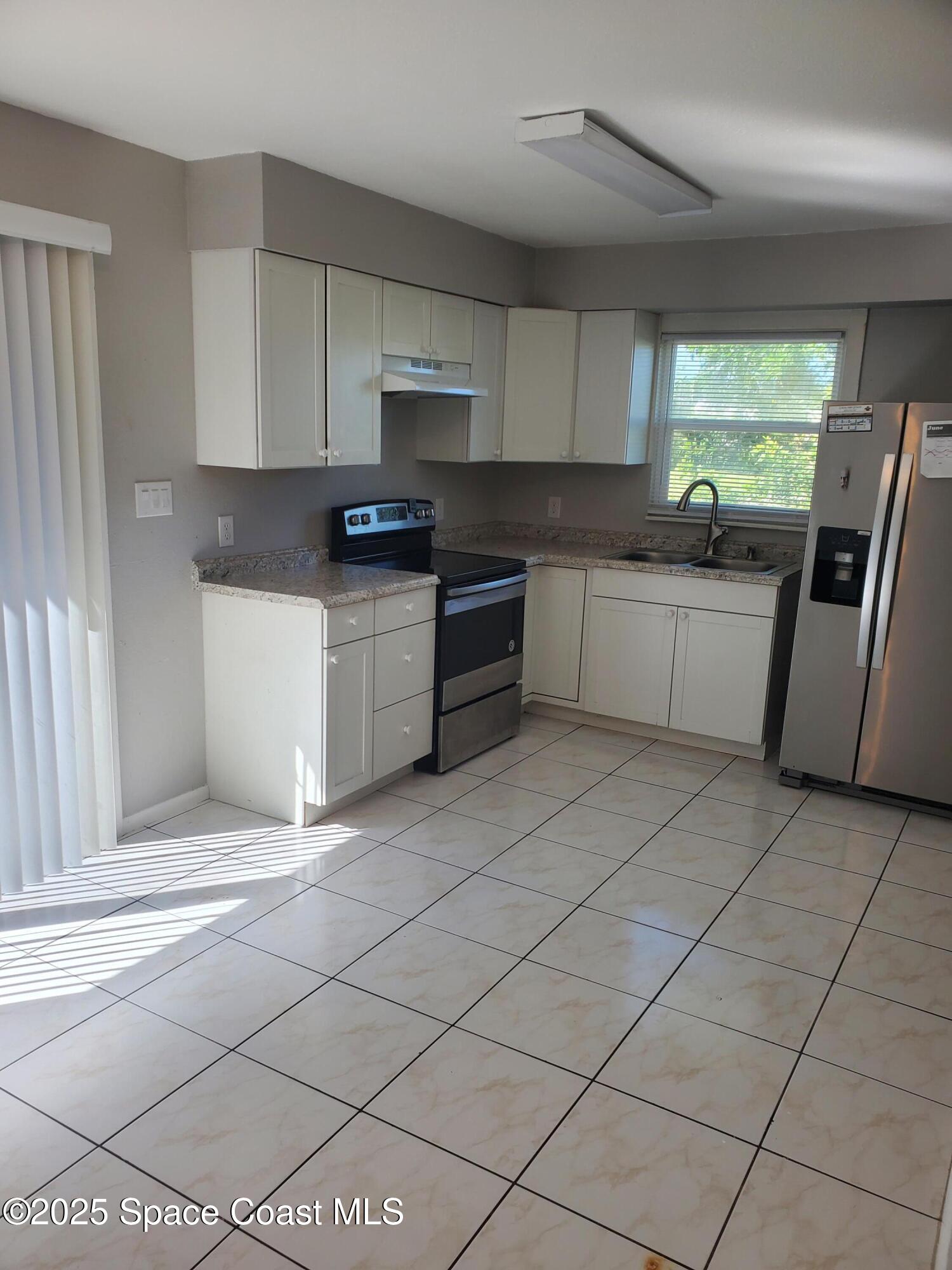 1105 Santa Rosa Drive Rockledge, FL 32955 - Photo 8 of 16 a kitchen with stainless steel appliances granite countertop a sink and cabinets