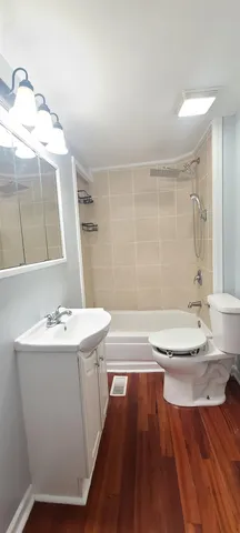 a white toilet sitting next to a bathroom sink