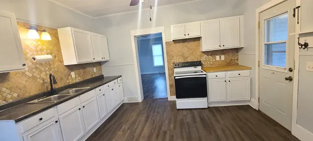 an empty room with wooden floor and a window