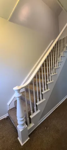a view of staircase with wooden floor