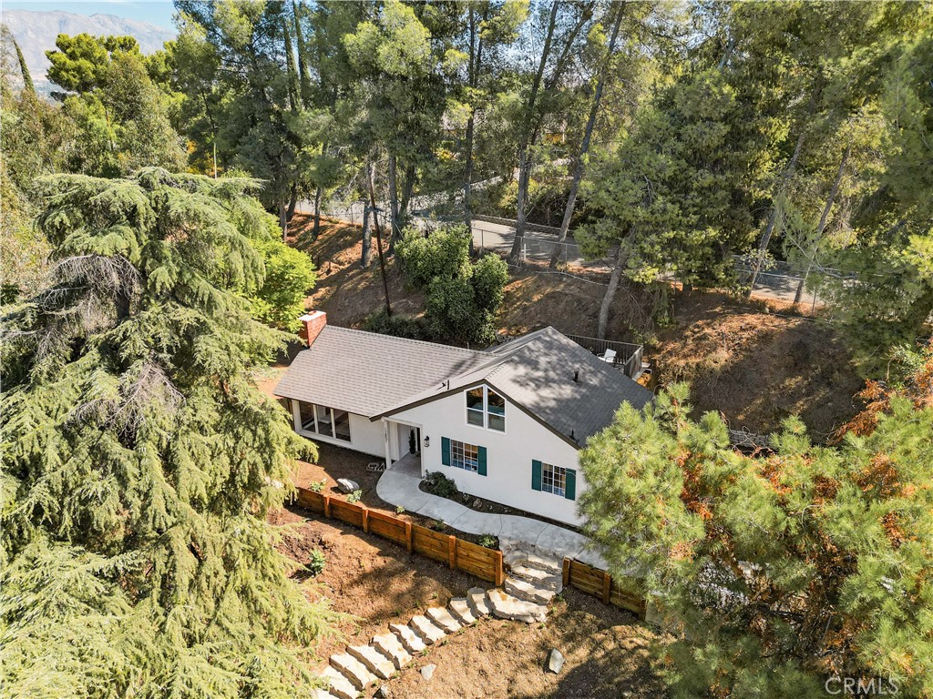 an aerial view of a house with a yard