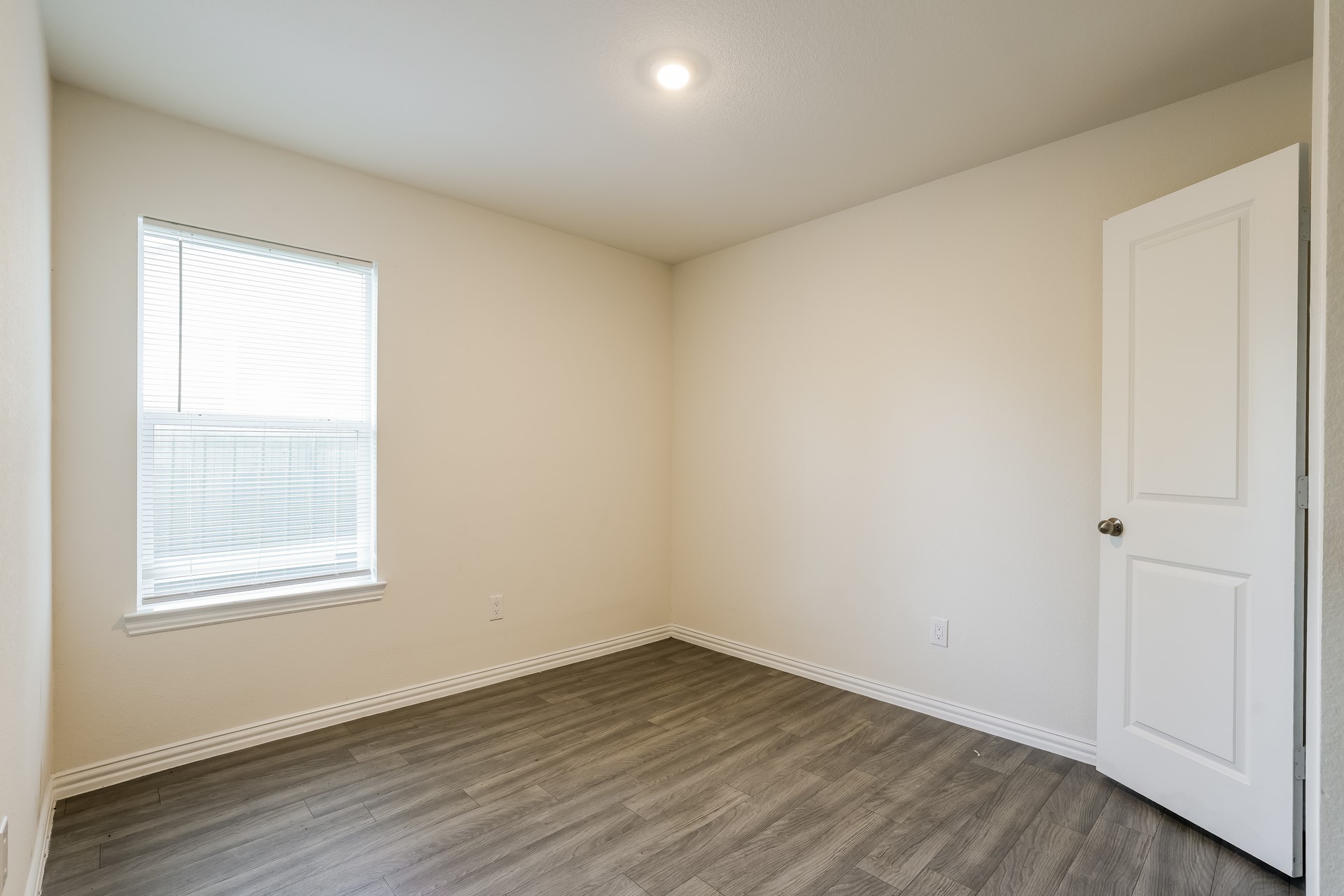 8213 Linda Vista Road Houston, TX 77028 - Photo 13 of 21 an empty room with wooden floor and windows