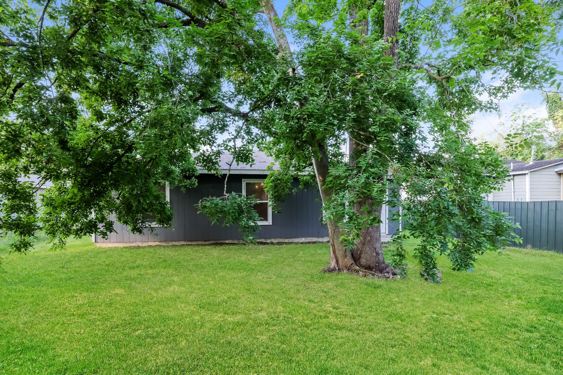 8213 Linda Vista Road Houston, TX 77028 - Photo 20 of 21 a view of a house with a yard and a tree